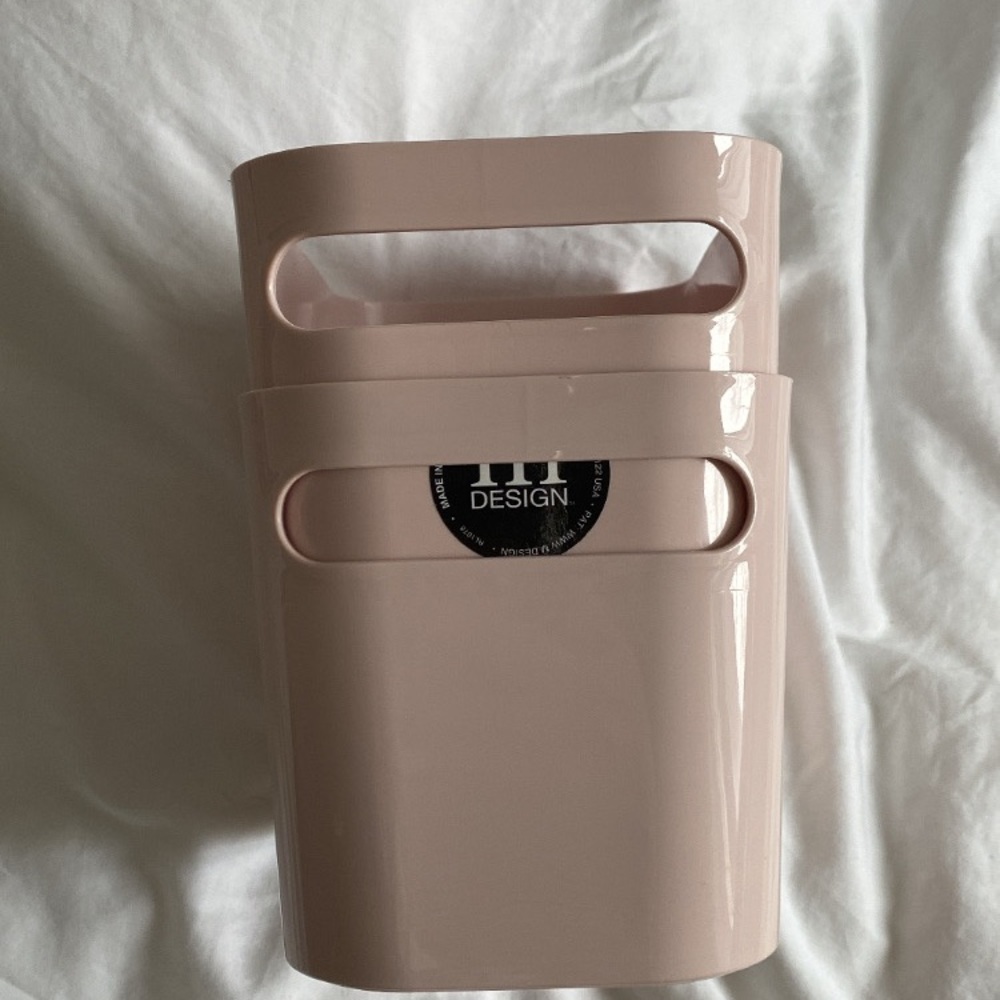 Two pink storage bins